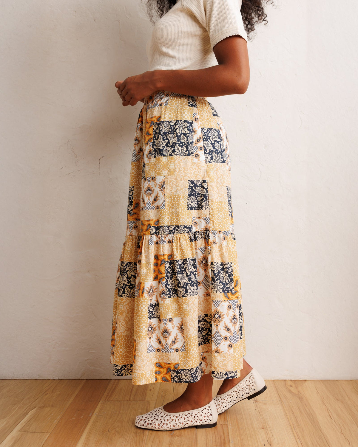 Tiered patchwork midi skirt with gathered ruffle tiers in orange-cream and navy