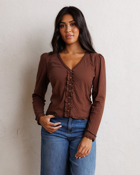 Brown cardigan with V-neck, long sleeves, button front, and cinched waist hem