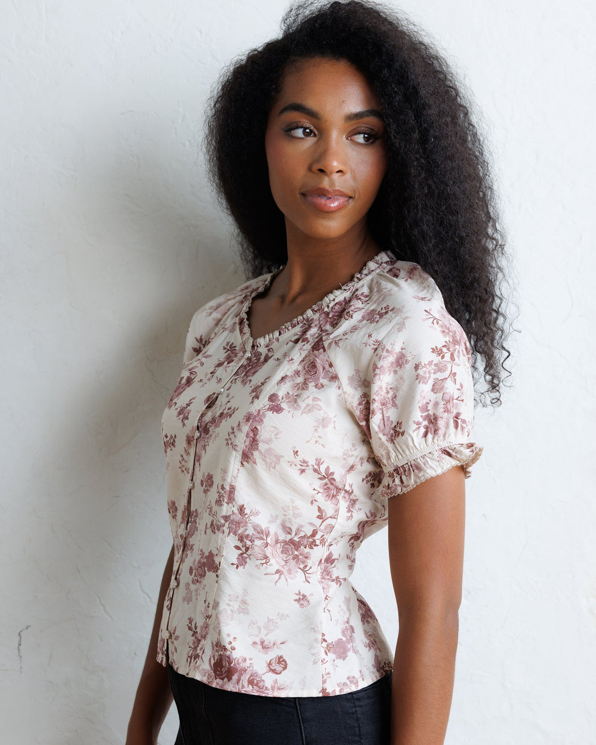 La Vie En Rose top with pale floral pattern, short puff sleeves, and center seam.