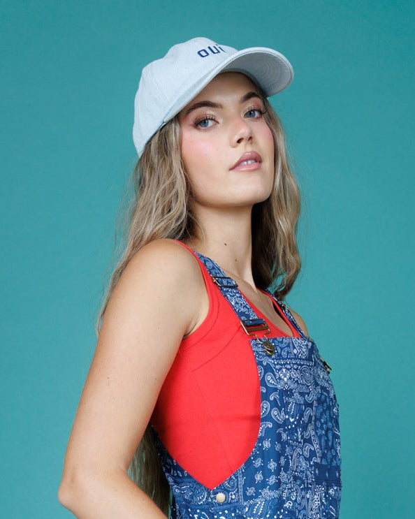 Light-blue 'oui' cap worn, curved brim and adjustable strap side detail
