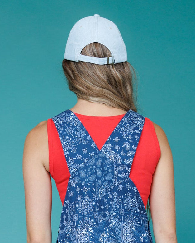 Light-blue 'oui' cap worn, adjustable strap visible at the back