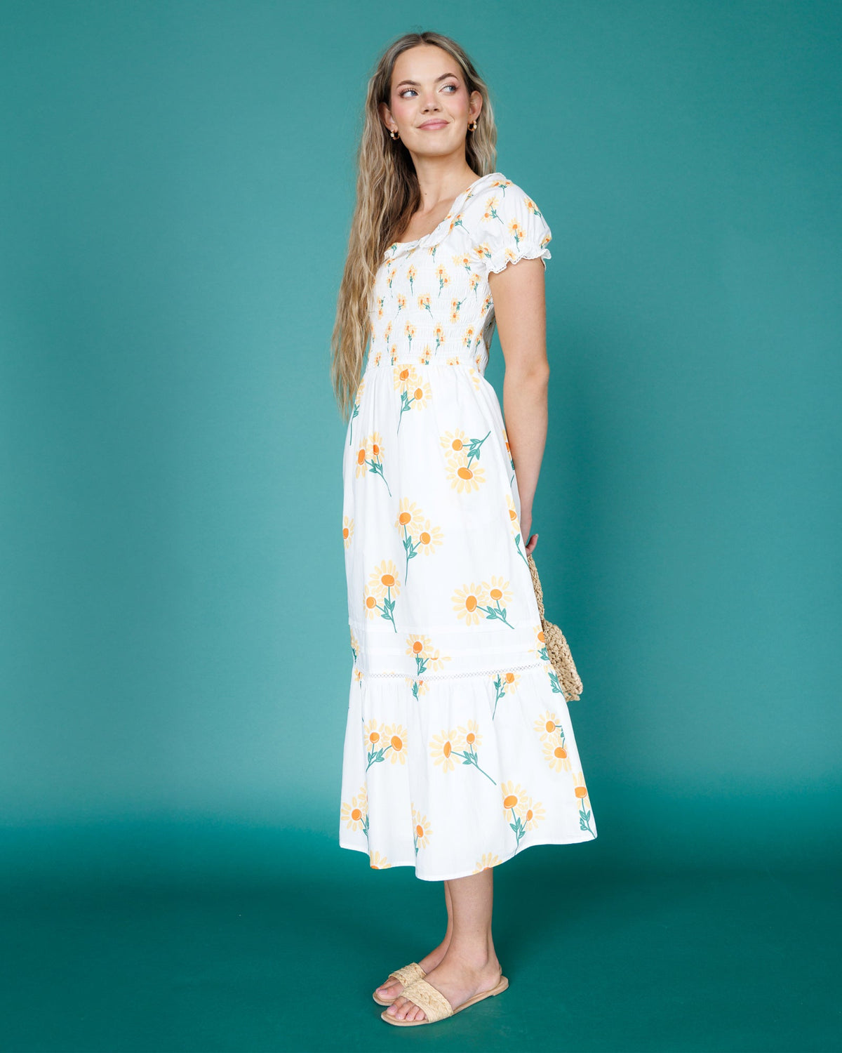 Front view of white floral tiered midi dress with square neckline and puff sleeves