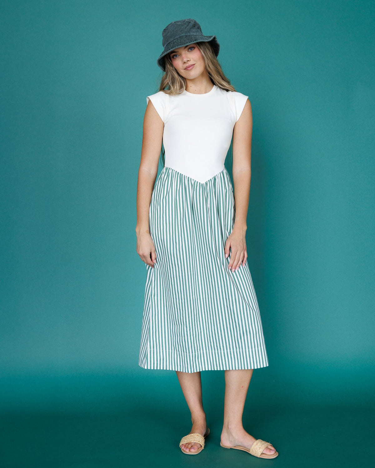 Sleeveless midi dress with white bodice and vertical blue-green striped skirt