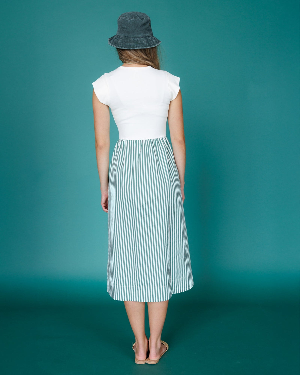 Back view sleeveless midi dress with white top and vertical blue-green striped skirt