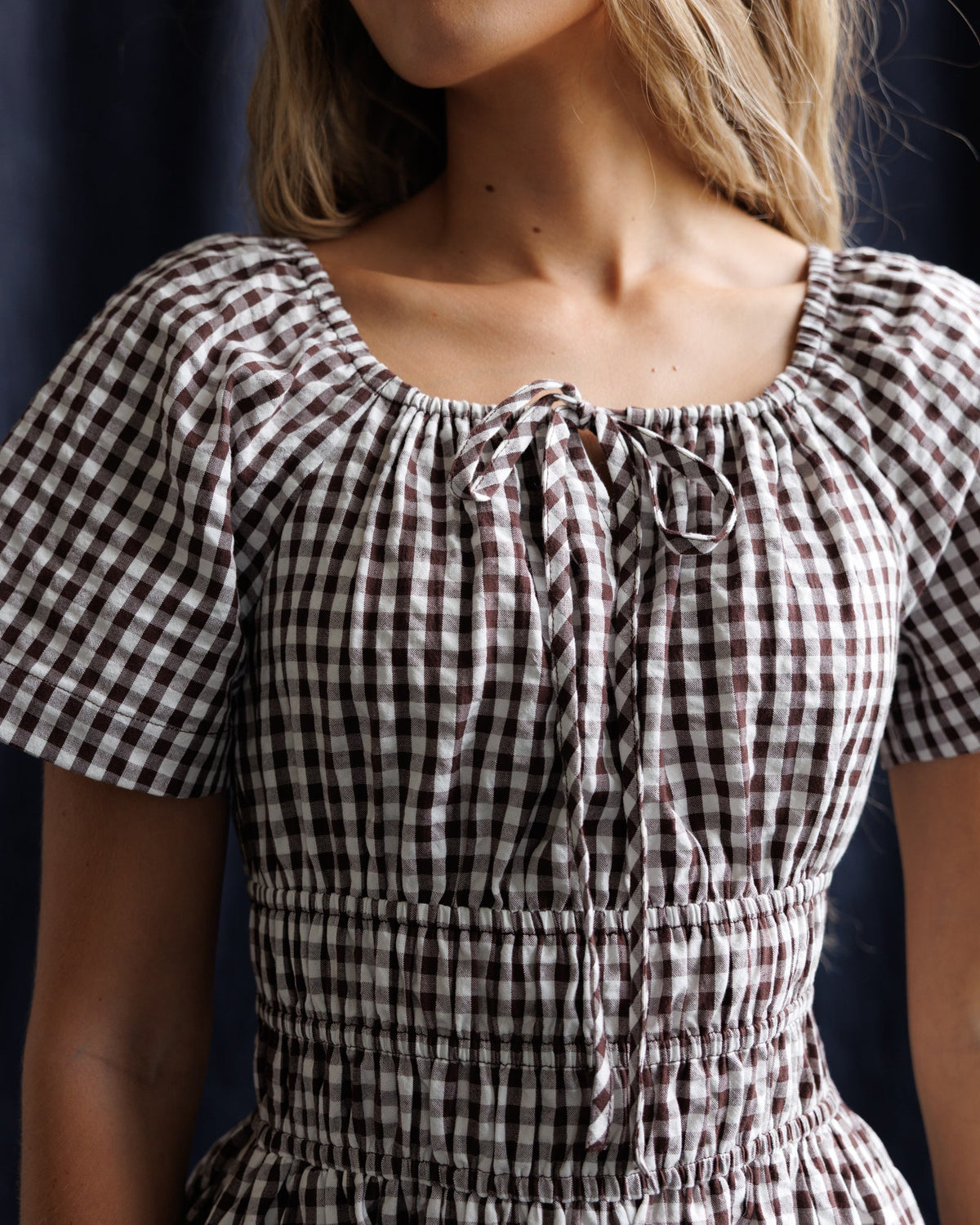 Maybelle dress bodice close-up: gingham ruched square neckline with bow detail