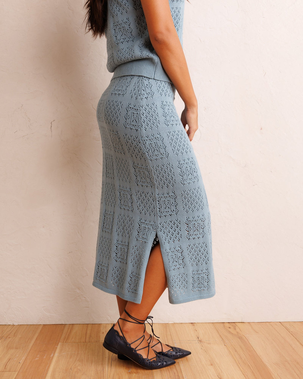 Smoke blue textured knit midi skirt with front slit and patterned knit panels