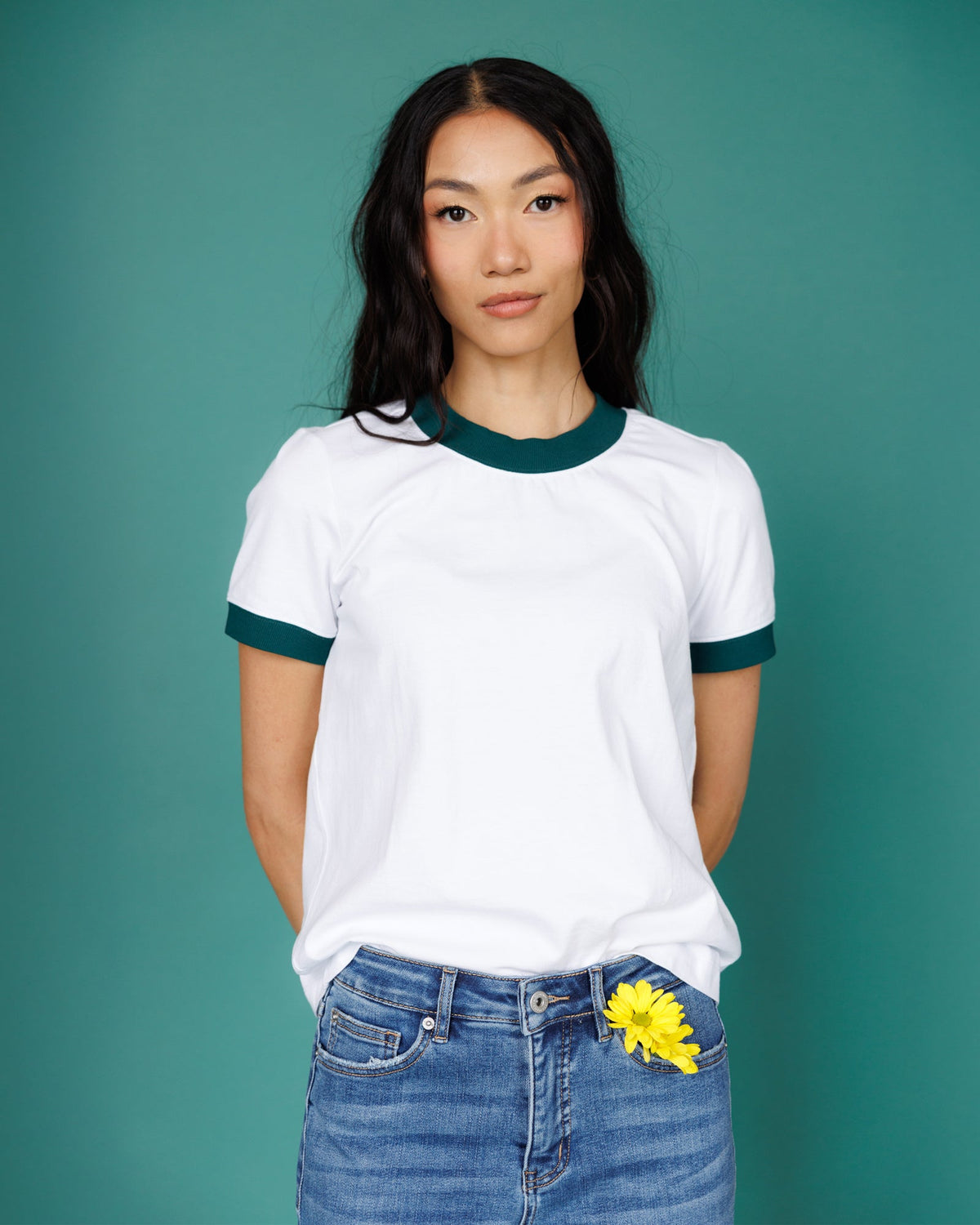 Bright white ringer T-shirt with dark green ribbed neckline and short sleeves
