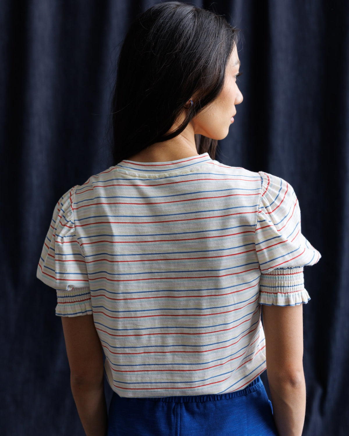 Women’s striped puff-sleeve top from the back with gathered sleeve cuffs