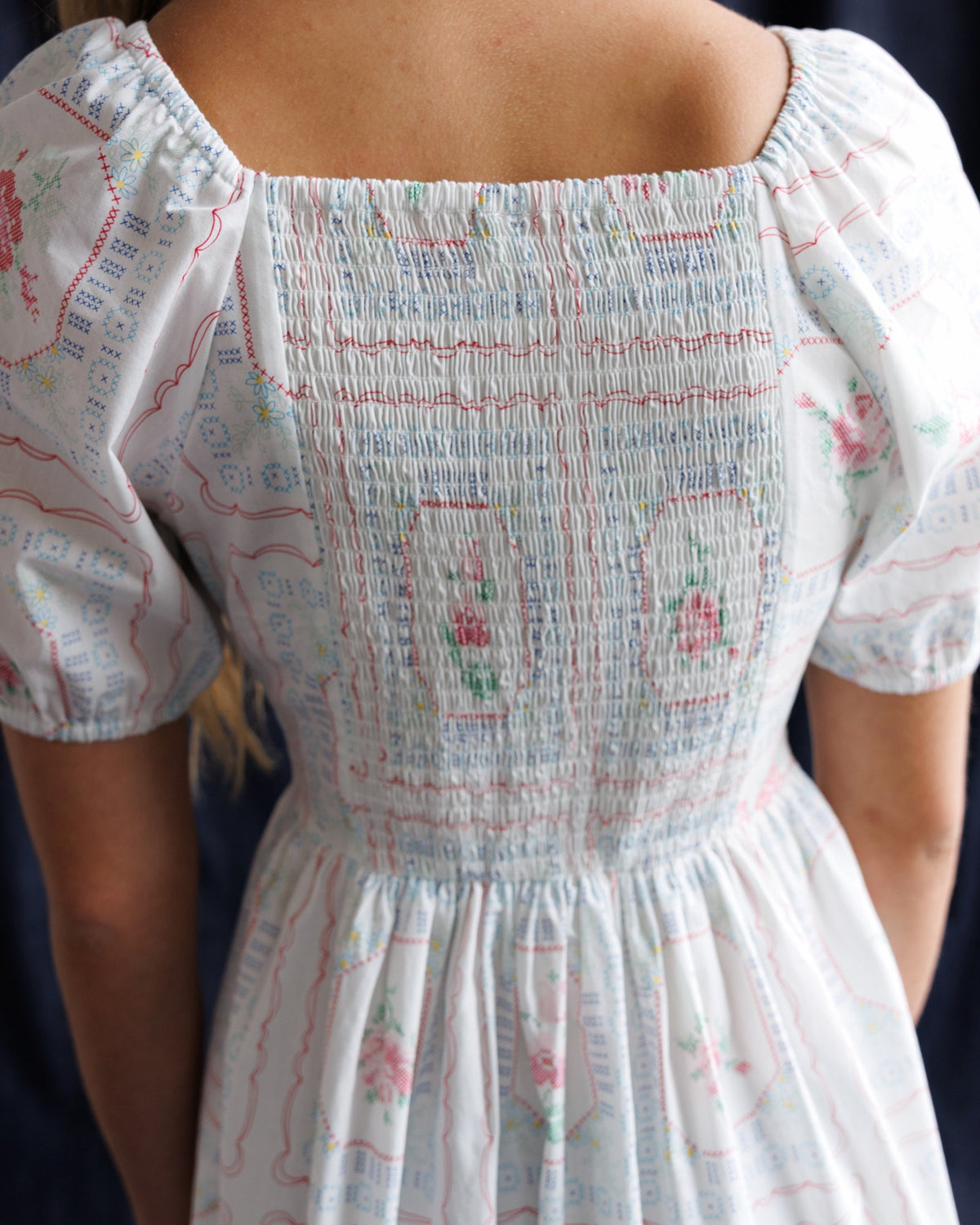 Smocked-back white dress with gathered waist and short puff sleeves, pastel print