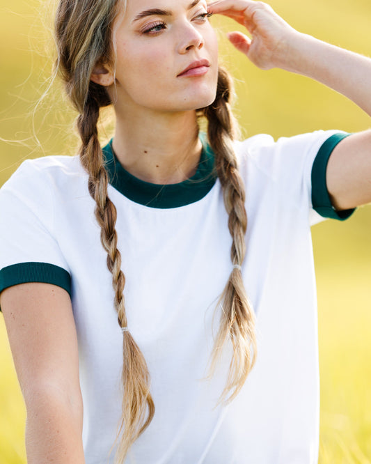 Bright white ringer T-shirt with dark green crew neck and sleeve cuffs