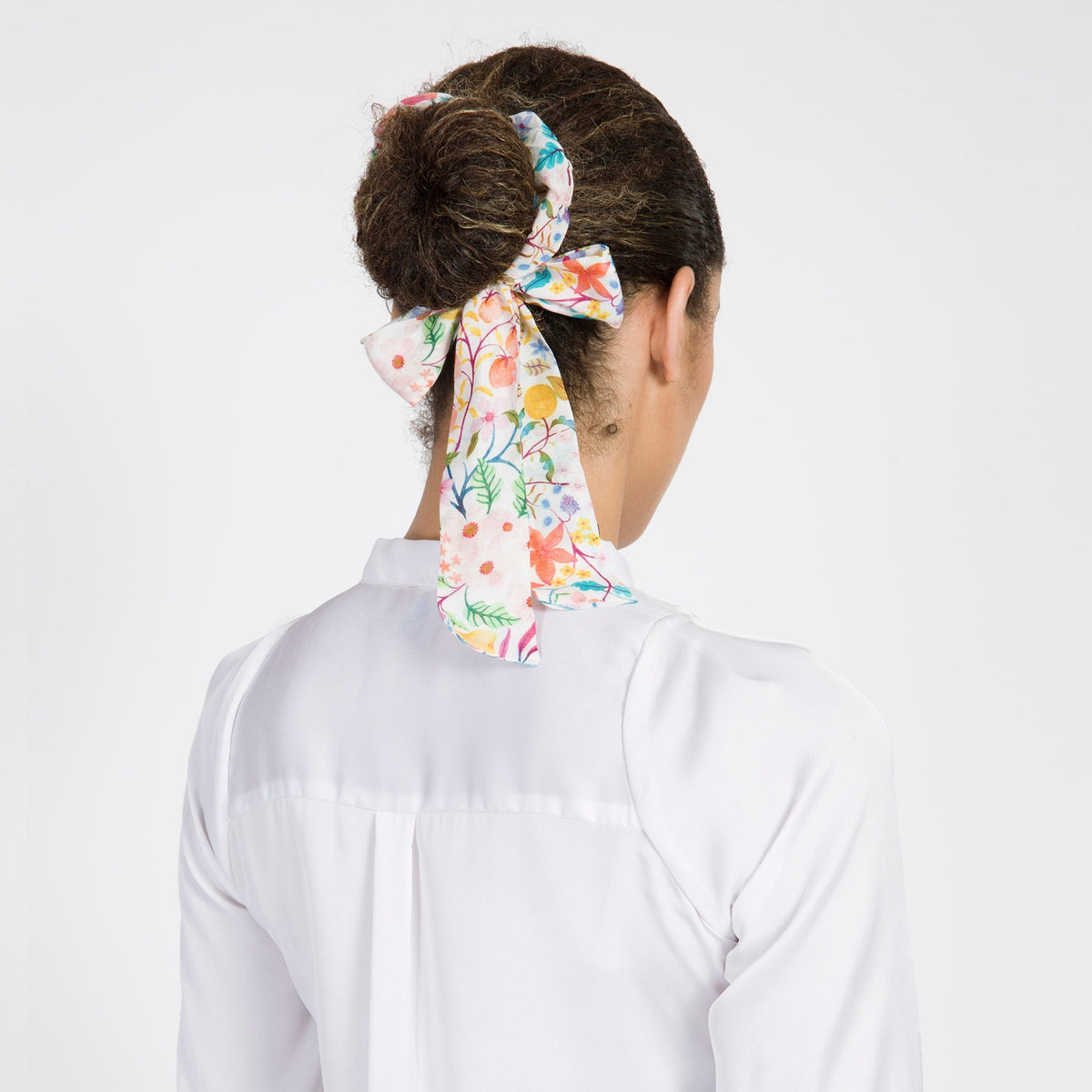 Floral hair scarf bow with long tails at the back of the head, colorful print