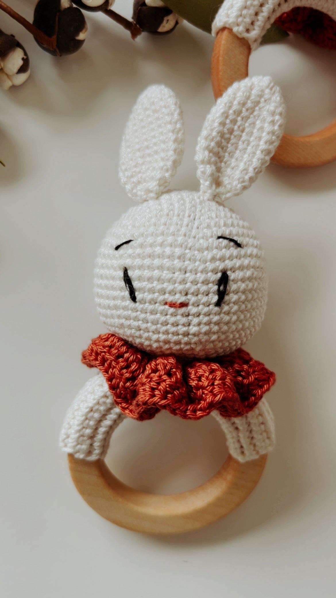 Bunny rattle teether: crocheted white bunny face with orange scarf and wooden ring