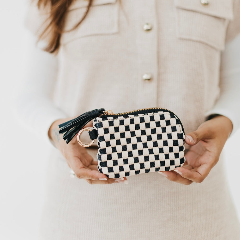 Black and white checkered card wallet with gold zipper, key ring, and tassel.