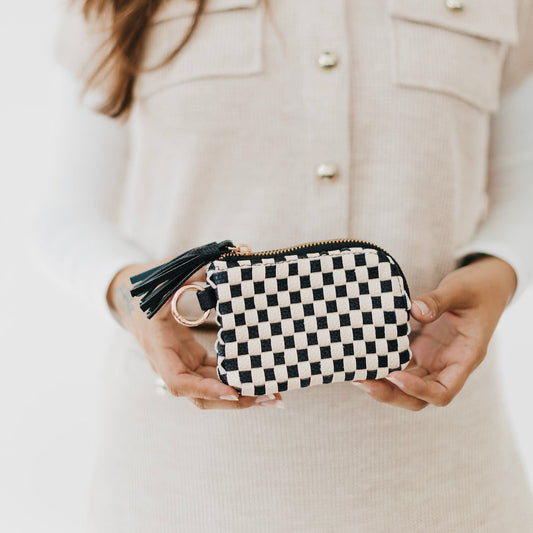 Black and white checkered card wallet with gold zipper, key ring, and tassel.