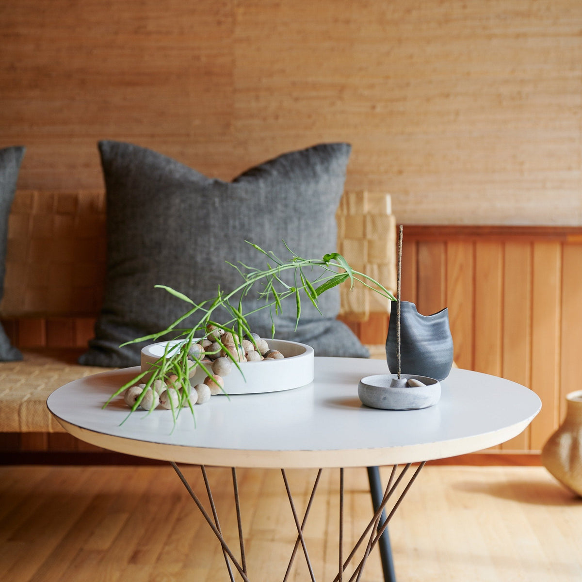 Black bird-shaped vase on tabletop, holds slender stems