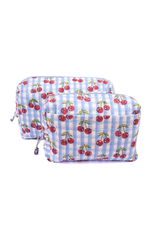 Zippered cherry-print makeup bag on blue check fabric, with side tie cords