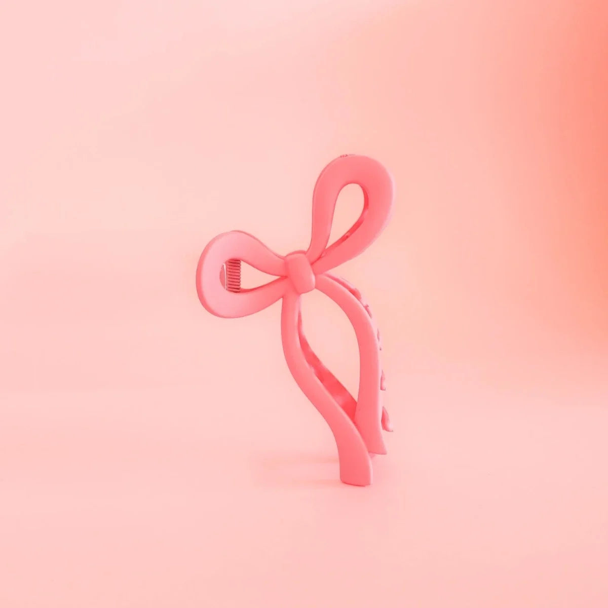 Pink bow hair clip with looped ribbon design