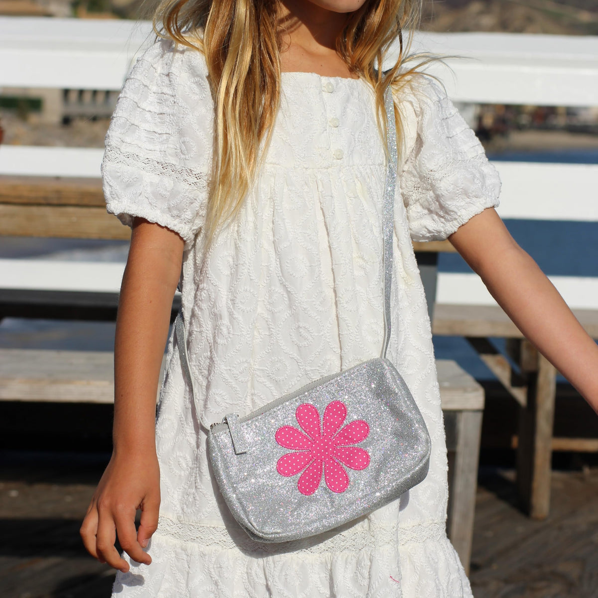 Silver glitter crossbody purse with pink flower front and adjustable shoulder strap