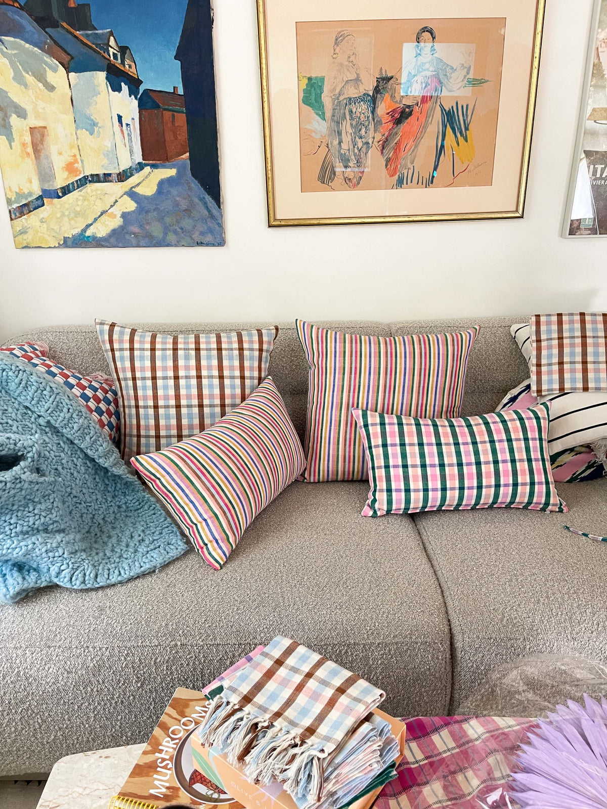 Plaid ruffle throw pillows with colorful checks on a sofa seating area