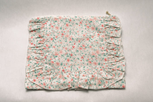 Pastel floral ruffle zip pouch with pleated sides and decorative zipper pull