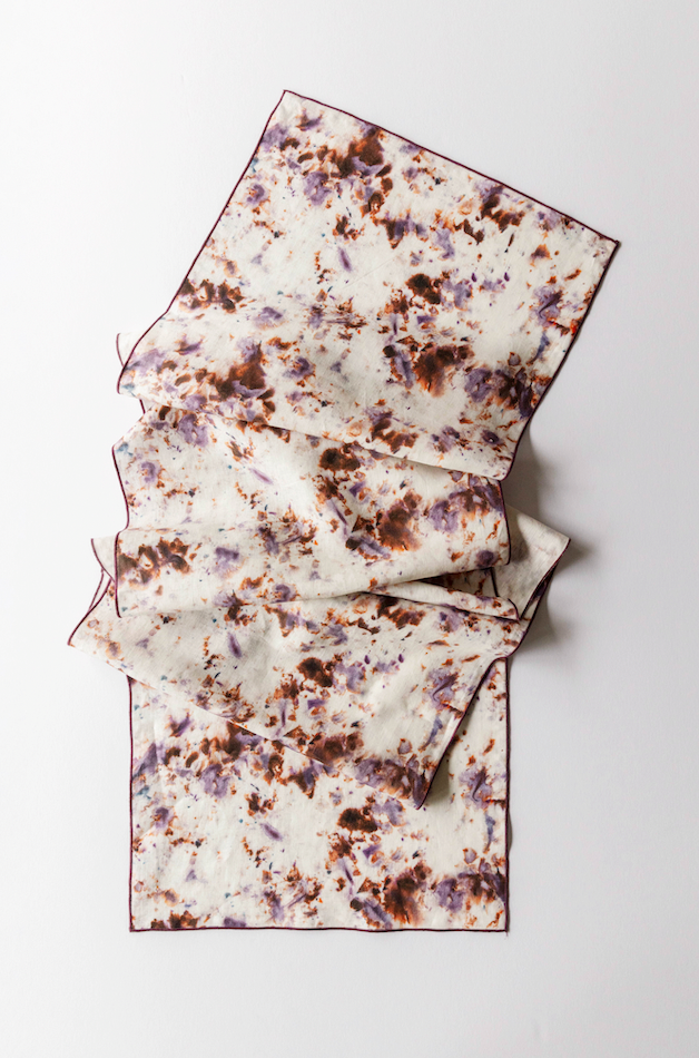 Stacked marble-pattern table runner pieces, white base with brown rose speckle print