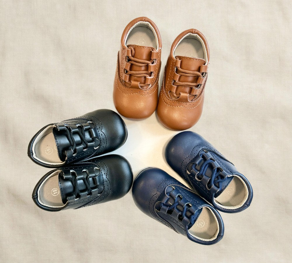Kids lace-up dress shoes with wide toe box, assorted colors shown together