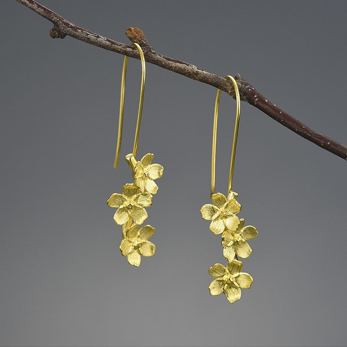 Gold hook earrings with layered forget-me-not style flower clusters
