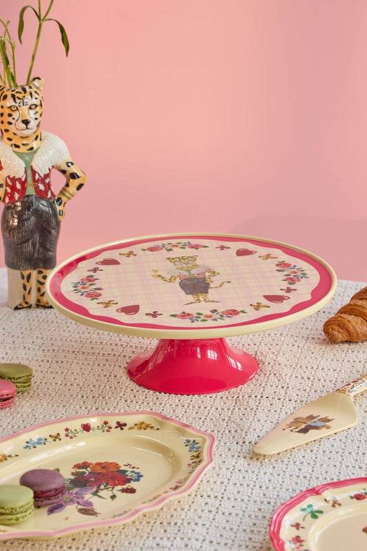 Low melamine cake stand on red pedestal with round bird-and-flower print top