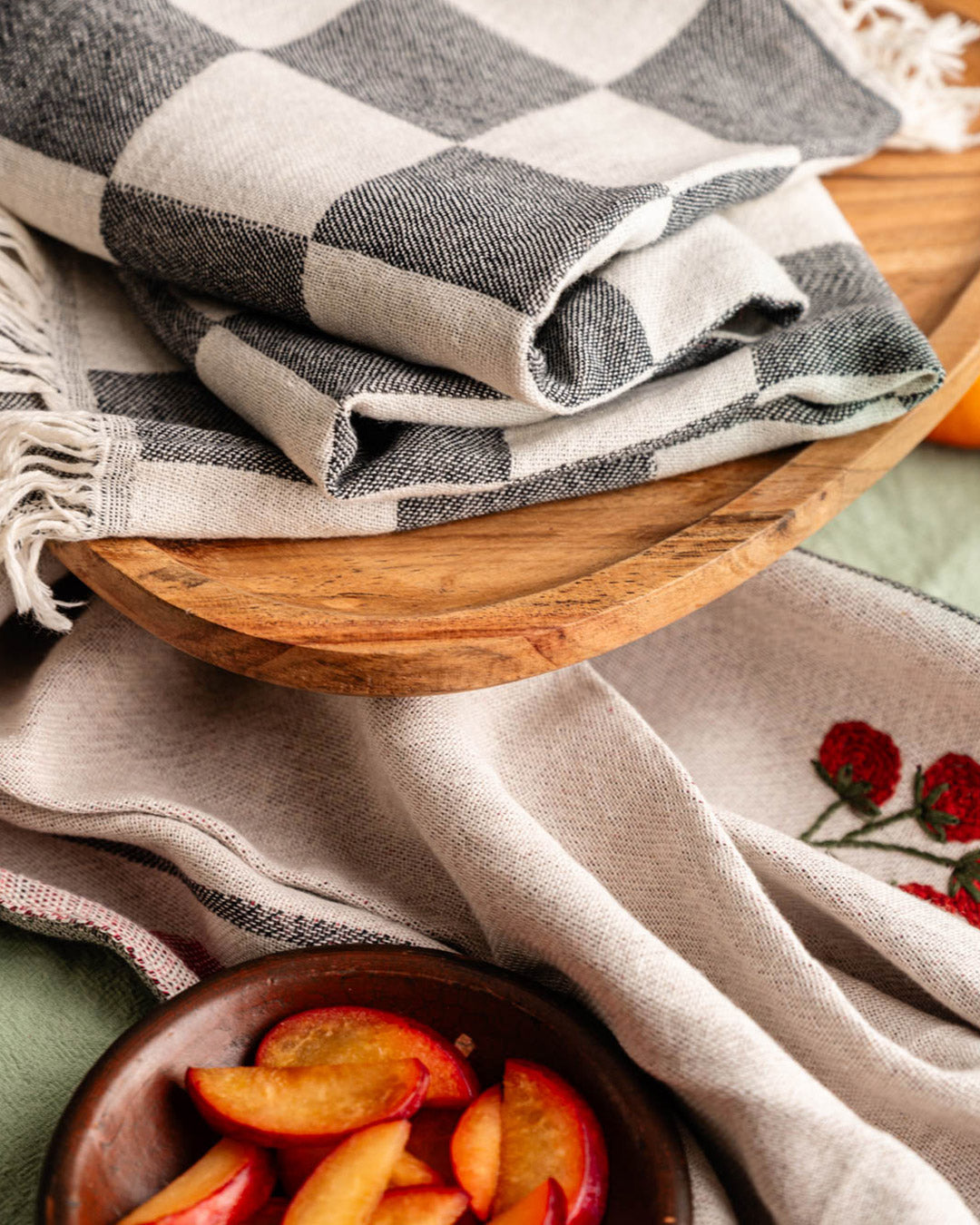 Fringed kitchen towel, beige with gray check border, red wavy stripe and small tomato embroidery