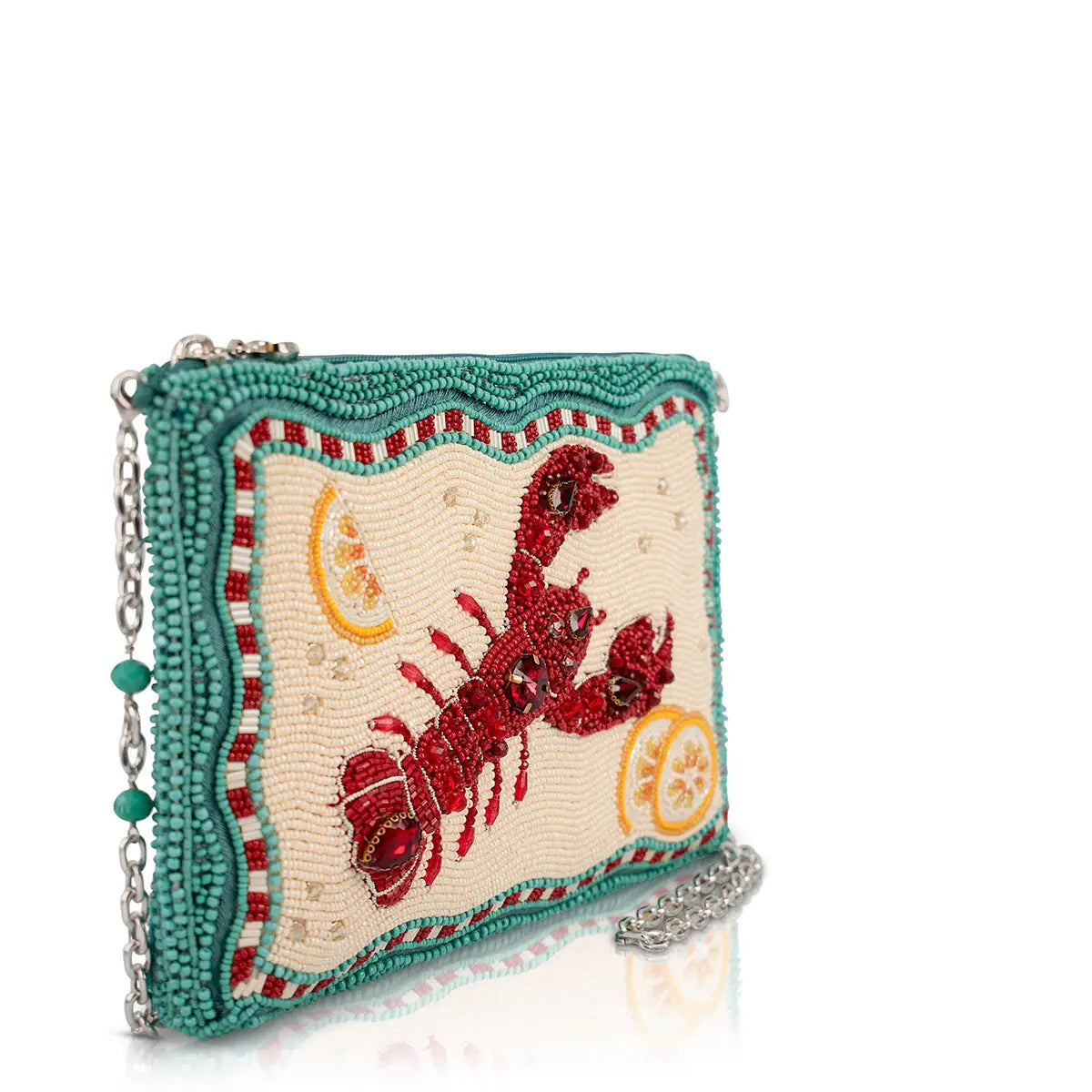 Beaded lobster handbag side view with teal trim, cream background, red lobster motif
