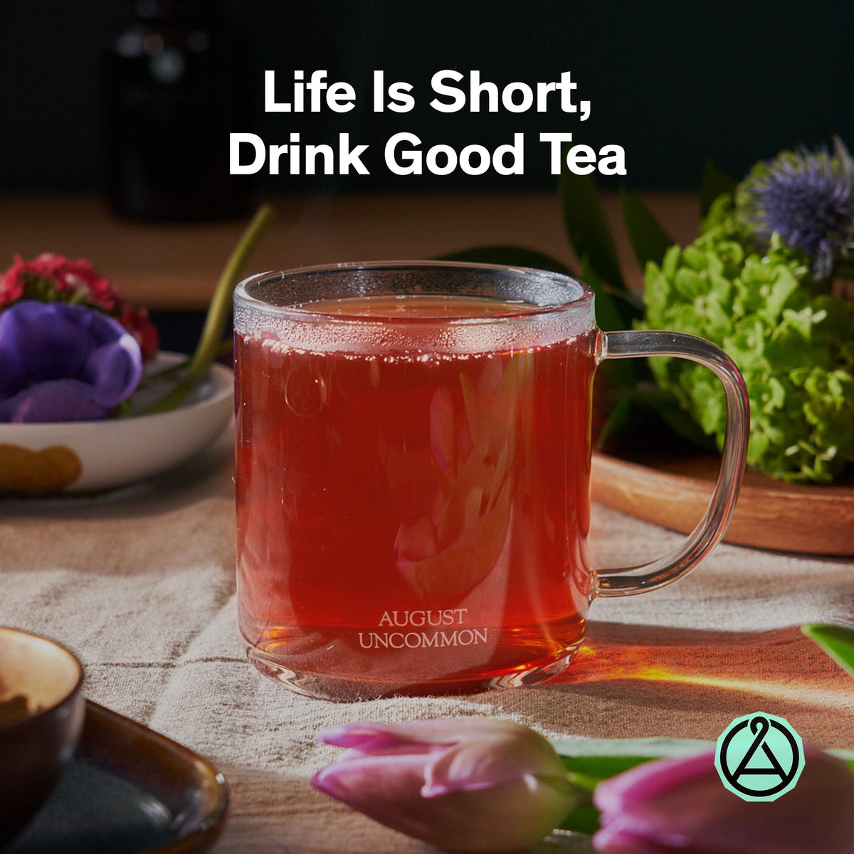 Glass mug of reddish amber August rooibos tea.