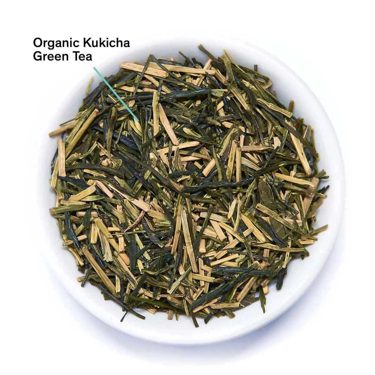 Loose green tea leaves with slender stems in a white bowl