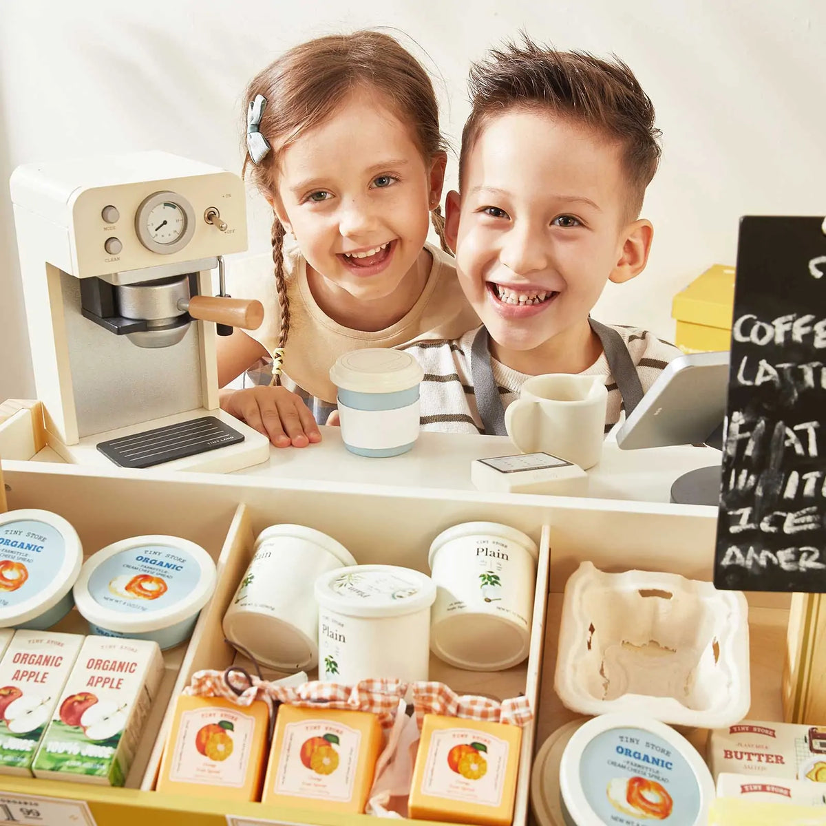 Grocery store playset cafe counter with toy coffee machine, cups, and packaged play food.