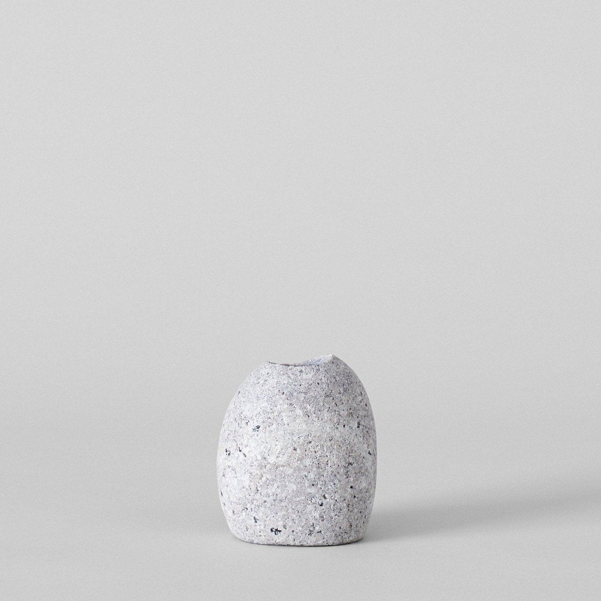 Grey stone match striker with match tips protruding from the top