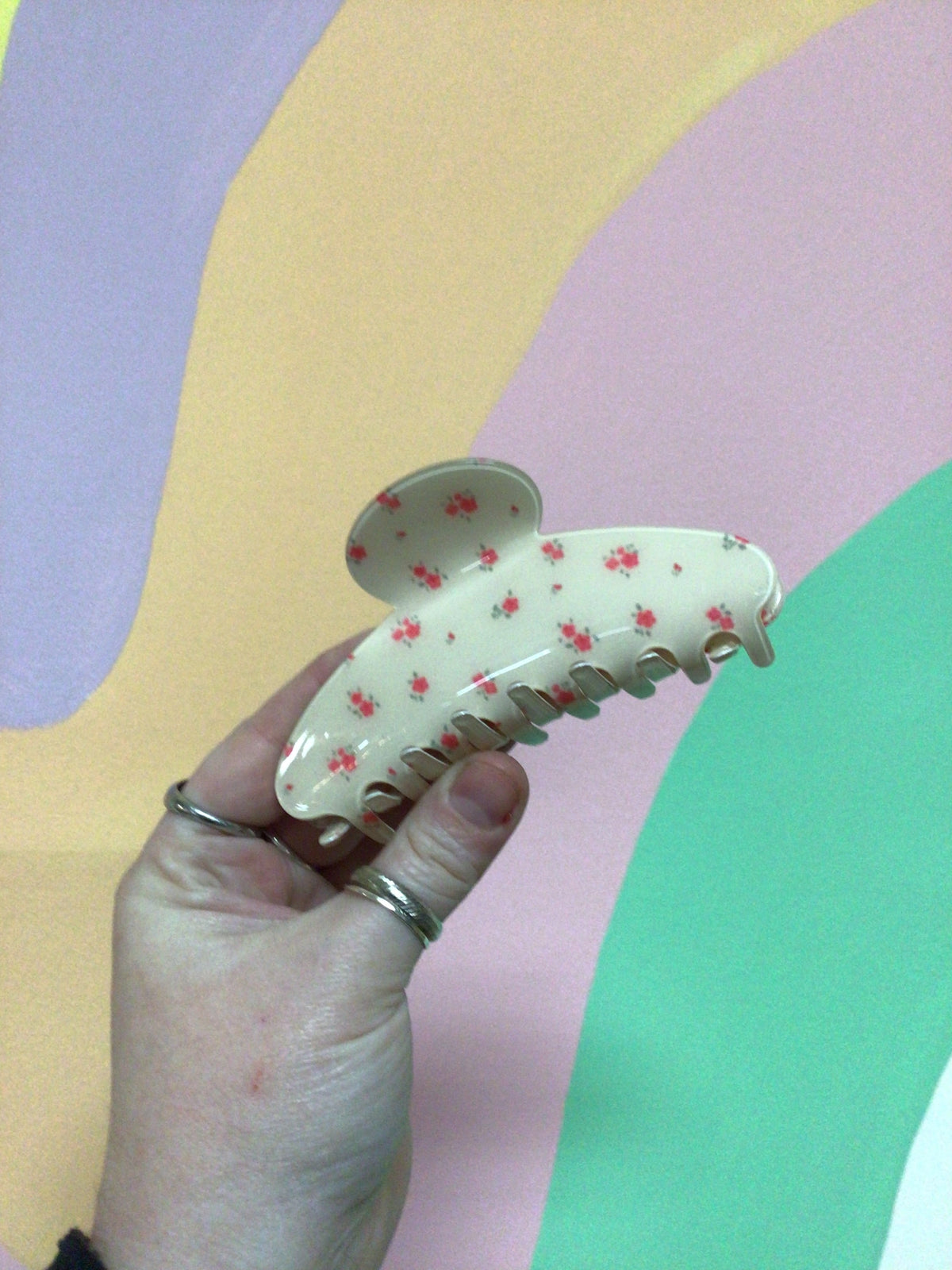 Cream toile hair claw clip with small pink and red floral print and curved teeth