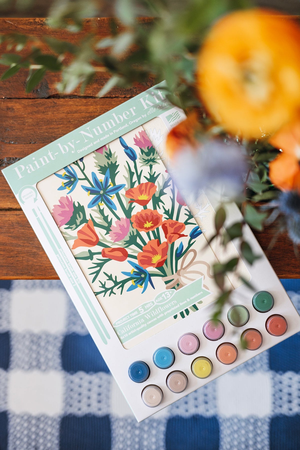 Paint-by-number wildflowers kit with floral template, paint color circles, and two pencils