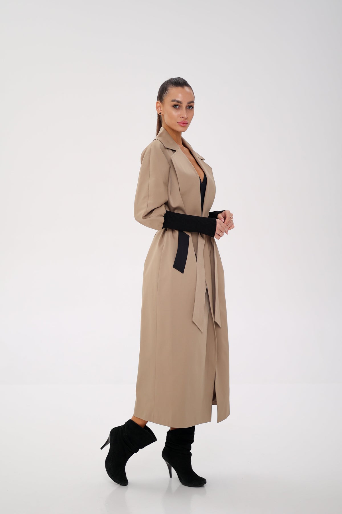 Miru camel trench coat shown from the side, with a long belted silhouette