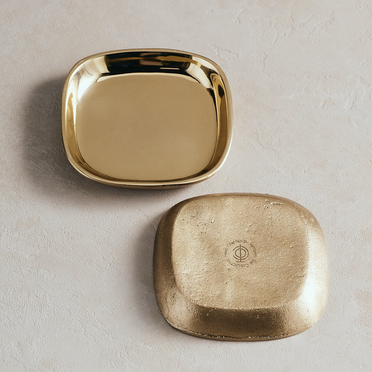 Gold oval catchall tray with matching textured base piece.