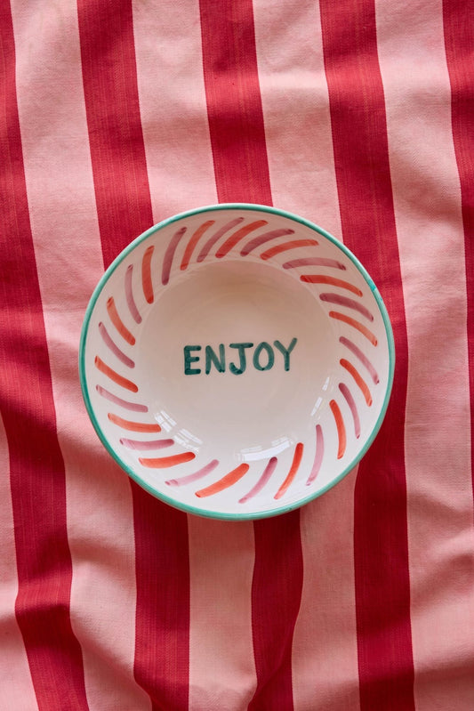 Large ceramic salad bowl with hand-painted ENJOY text and striped rim