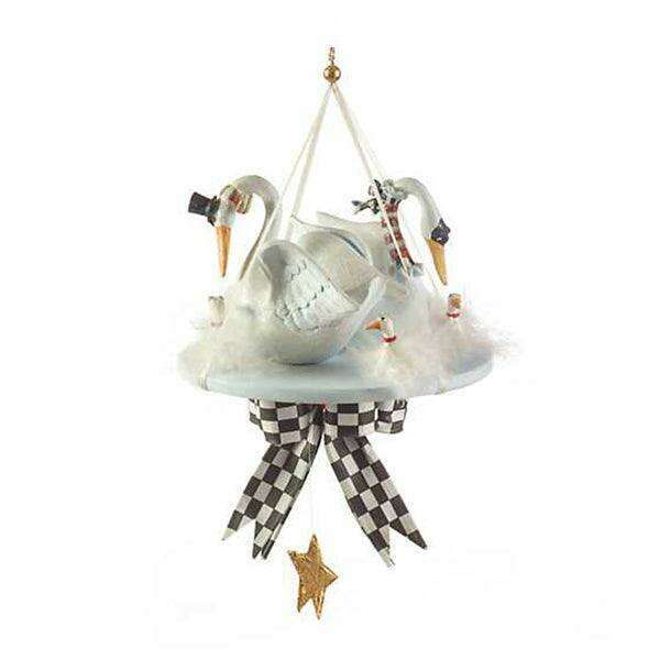 White swan ornament with black checkered ribbon skirt and gold star hanging charm.