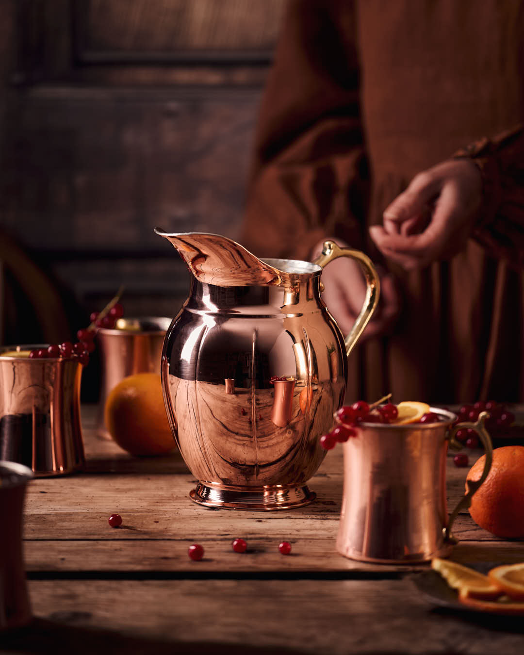 Copper vintage-style pitcher with flared spout and gold-toned handle, close scene.