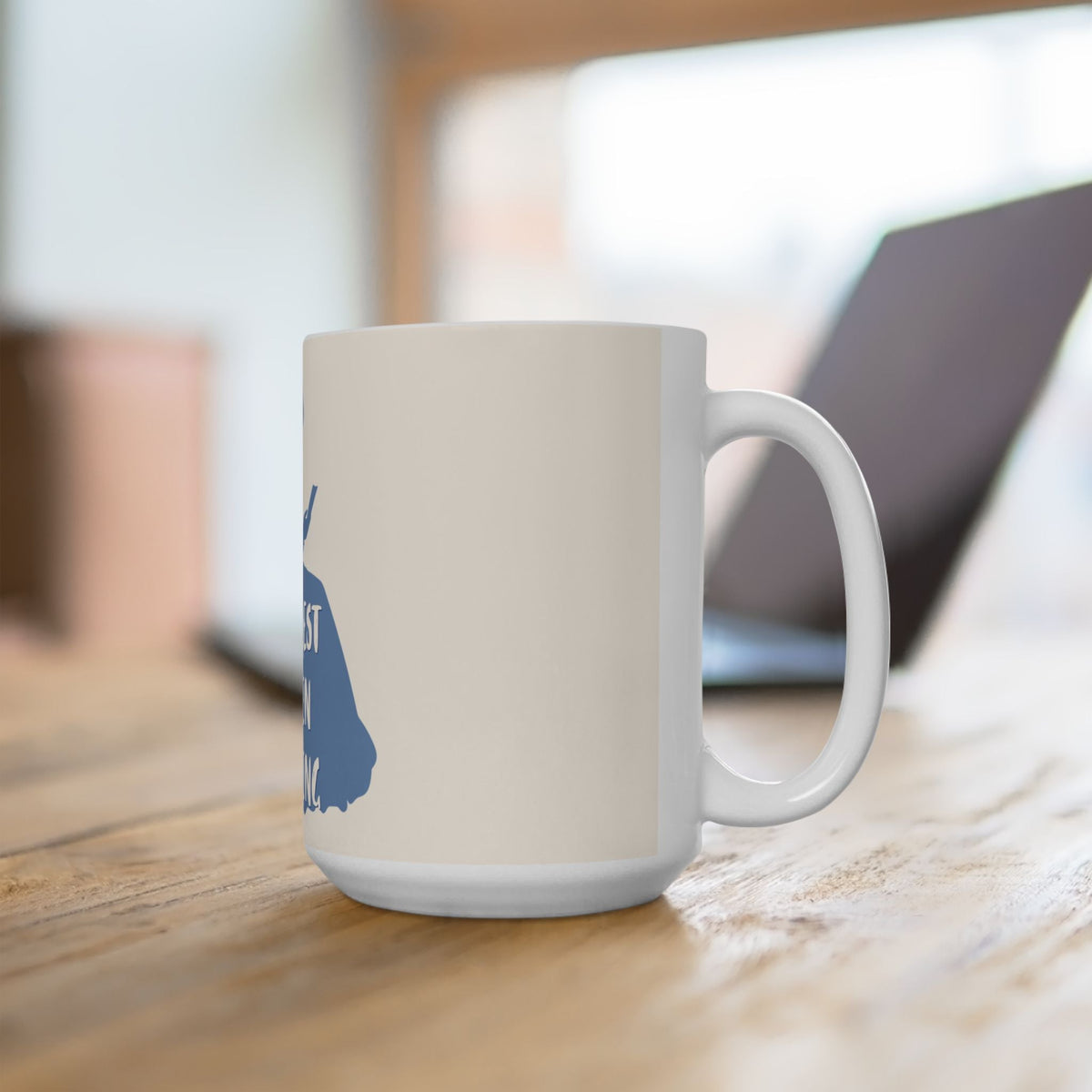 Ceramic mug with partial blue reading graphic on side and white handle