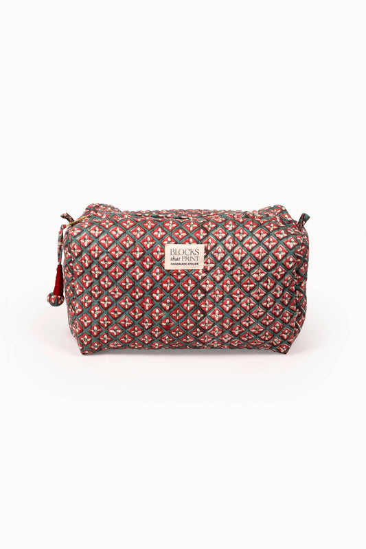 Quilted travel pouch with red and multicolor block print, top zip and wrist strap