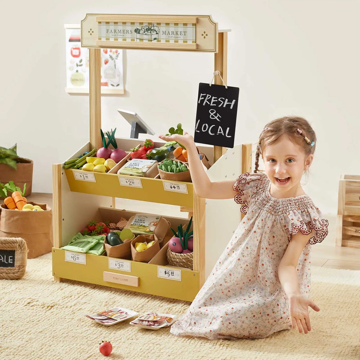 Wooden grocery store playset with produce display and hanging market sign.