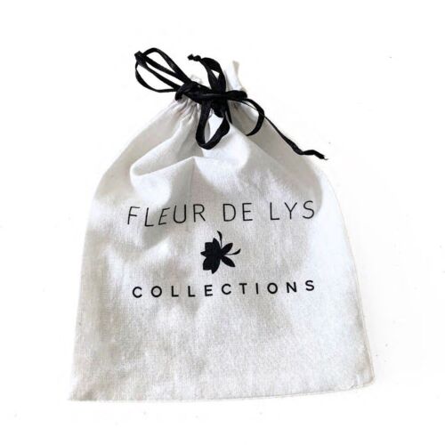 White drawstring gift pouch with black ribbon and 'FLEUR DE LYS COLLECTIONS' text