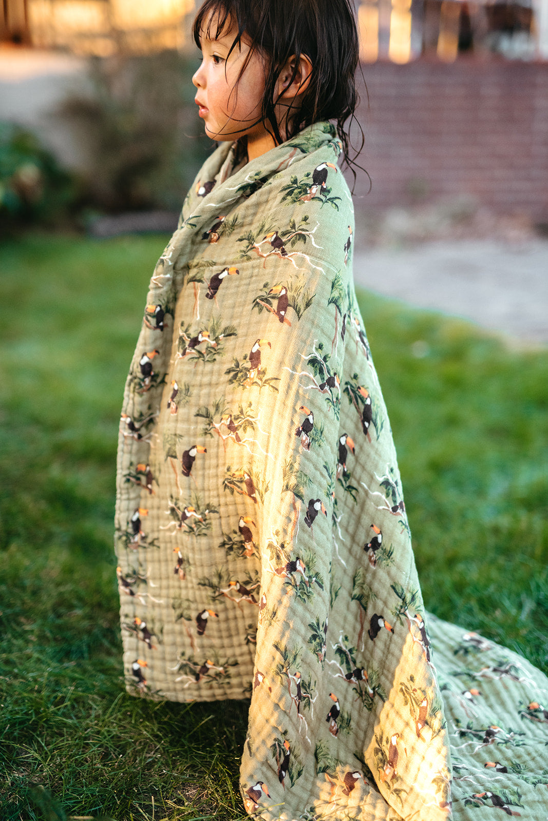 Children wrapped in tulip beach and swim towel, light green with multicolor tulip print
