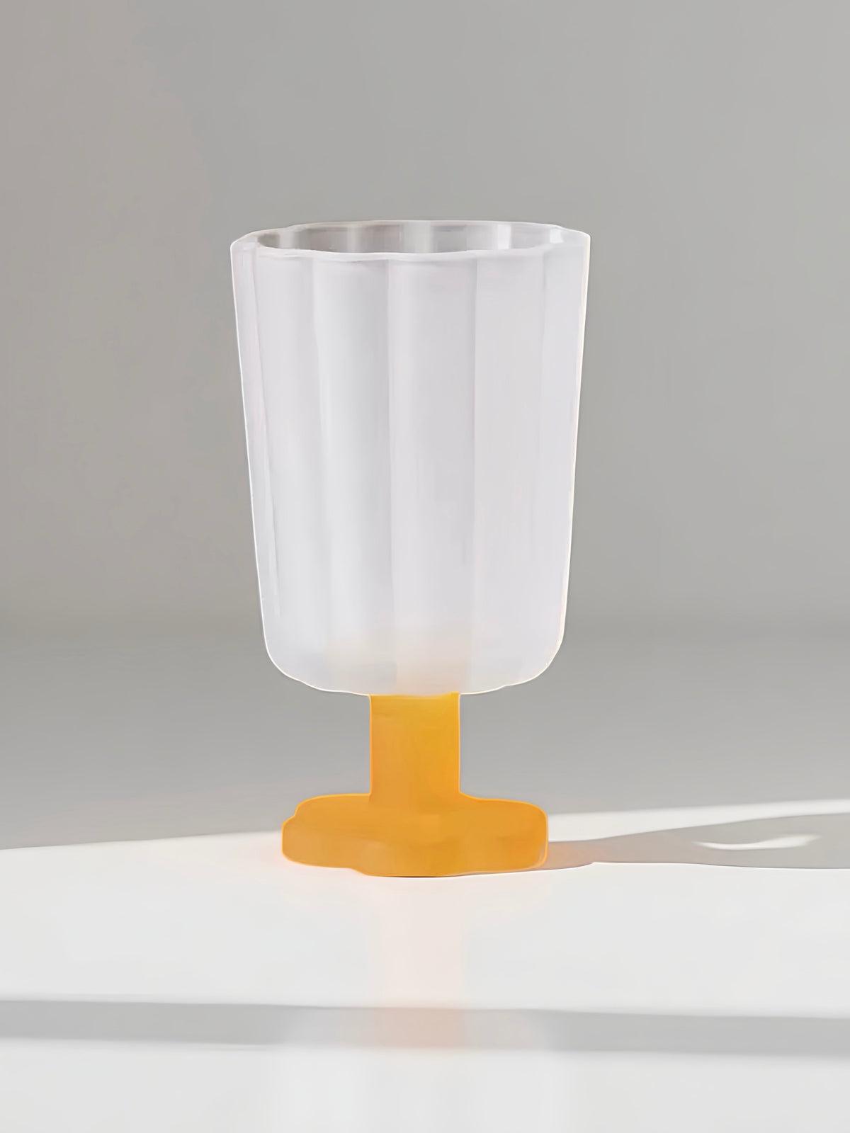 Clear white petal goblet with flared rim and orange stem pedestal base
