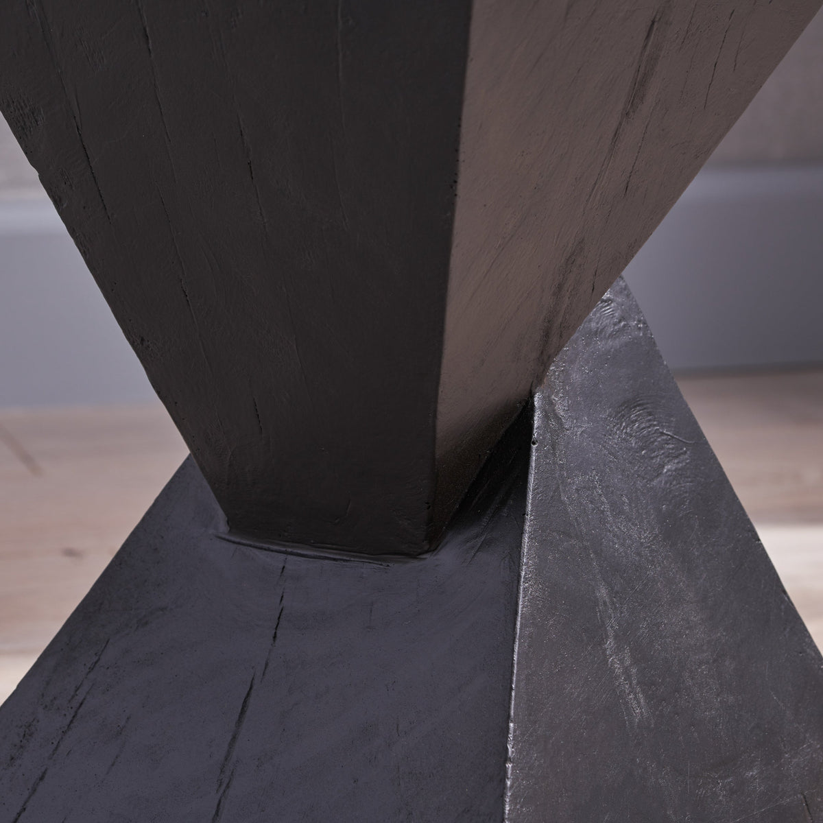 Close-up of the black table's textured finish and tapered center joint