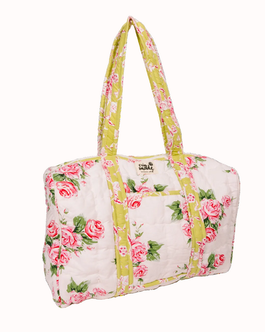 Quilted duffle bag with pink rose print and yellow-green handles, soft zip top