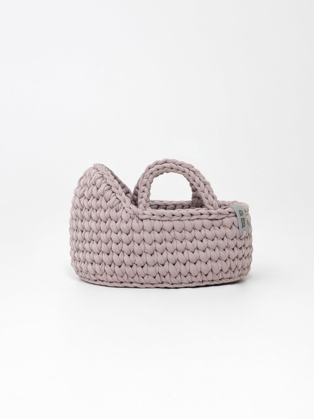 Mini doll moses basket, mauve-pink woven basket with curved handle and side label